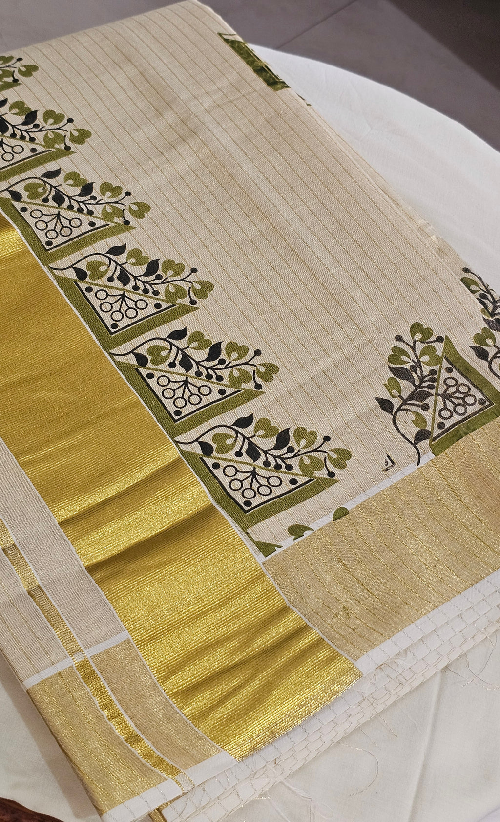 Striped kasavu saree with olive green & black prints - KM 422